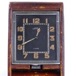 JAEGER - a leather-cased folding desk timepiece, luminous Arabic numerals and hands, 8-day movement,
