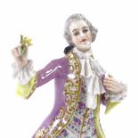 A Volkstedt porcelain figure of a gentleman holding a flower, height 17cm