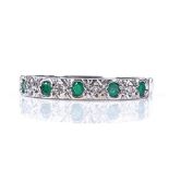 An 18ct white gold emerald and diamond half-hoop ring, setting height 3.2mm, size Q, 2.9g