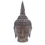An Oriental silver patinated bronze Buddha head, height 18cm