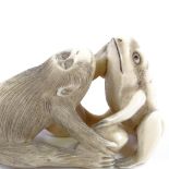 A Japanese Meiji Period carved ivory netsuke, in the form of a monkey and a frog, length 6.5cm