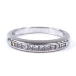 A platinum and Princess-cut diamond half-hoop ring, setting height 3.1mm, size M, 5.4g