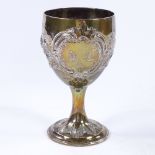 A Georgian silver wine goblet, with relief embossed floral and foliate decoration, indistinct