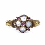 A Victorian 15ct gold opal and ruby dress ring, with relief engraved foliate shoulders, hallmarks