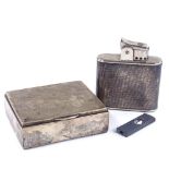 A large silver-cased table lighter, height 9cm, matching cigar cutter, and a silver cigarette box (