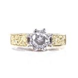 An 18ct gold solitaire diamond ring, with engraved foliate shoulders, diamond approx 0.4ct, maker'