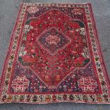 A Persian handmade red and blue ground rug, 7'9" x 5'11"