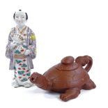 A Chinese Yixing red ware turtle design teapot, length 22cm, and an Oriental porcelain standing