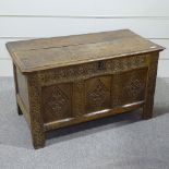 An 18th century oak blanket chest of small size, with carved 3-panel front, width 3'4", height 23"
