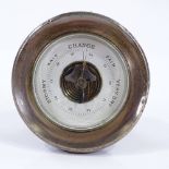 A silver-framed desk barometer with oak back, hallmarks Birmingham 1924, 10cm across