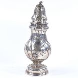 A large Continental silver sugar caster, with relief embossed floral decoration, stamped 830, height