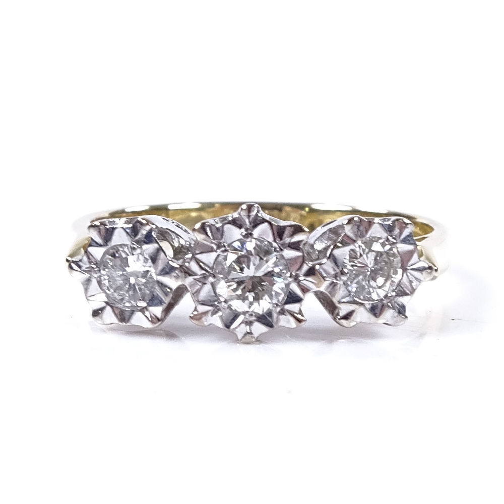 An 18ct gold diamond trilogy ring, total diamond content approx 0.72ct, setting height 6.5mm, size