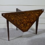 An 18th century Dutch marquetry folding card table, on original fluted tapered and inlaid legs,