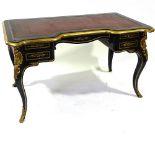 A 19th century French ebonised writing desk, with brass edges and inlaid brass marquetry on cabriole
