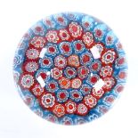 A Millefiori glass paperweight with blue and red canes, diameter 9cm, height 7cm