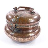 A large Islamic copper food container, with swing handle and engraved decoration, diameter 28cm