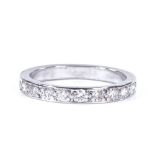 An unmarked platinum diamond half-eternity ring, total diamond content approx 0.3ct, band width 2.