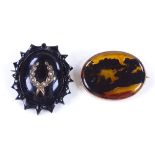 An oval agate panel brooch, in 9ct frame, length 35.7mm, 6.9g, together with a carved Whitby jet and