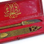 An Islamic calligraphy knife in original gilded leather case, length 22cm