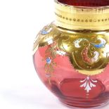 A Bohemian gilded and enamelled cranberry glass pot, height 9cm