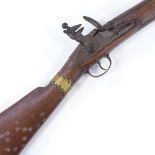 An Antique Indian Flintlock Blunderbuss, with engraved barrel, lock stamped T Potts London, brass