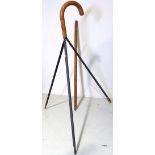 A rare early 20th century Jaki tripod walking stick, the handle unscrewing to reveal a removable...