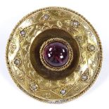 An unmarked gold foil back cabochon tourmaline and split-pearl circular brooch in rope twist