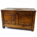 An 18th century fruitwood blanket chest, with plank top and fielded 2-panel front, width 4'3",