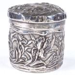 An Art Nouveau Edwardian cylindrical silver lidded box, with relief embossed floral decoration, by