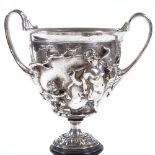 A 19th century electroplate 2-handled cup, decorated with Classical figures in high relief, on