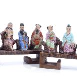 2 sets of 4 Chinese ceramic seated figures on wooden stands, length 18cm