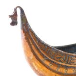 An Islamic 19th century copper bowl with bands of text, length 29cm