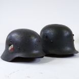A German M40 helmet, with M31 type liner (chin strap missing), and an Austrian Stahlhem M1916 type