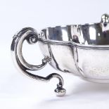 An Edwardian circular silver lobed bowl, with 3 C-handles, by Horace Woodward & Co for Mappin &