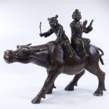 WITHDRAWN A large Chinese patinated bronze sculpture of 2 children riding a water buffalo,