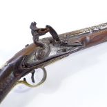 An Antique Indian Flintlock Blunderbuss pistol, silver inlaid barrel, with engraved lock and brass