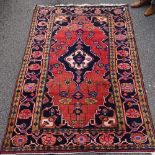 A Persian red and blue ground rug, 6'11" x 4'10"