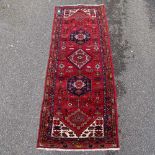 A handmade Caucasian red and blue ground geometric design runner, 6'5" x 2'5"