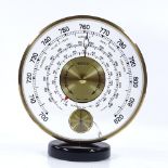 A Jaeger desk-top barometer with inset thermometer dial, 16cm diameter, glass cracked