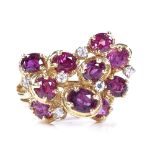 A 14ct gold ruby and CZ cluster abstract cocktail ring, with stylised openwork settings, setting
