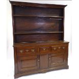 An 18th century American (Virginian) walnut dresser, with boarded open plate rack above, 3 frieze