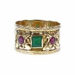 An unmarked gold 3-stone emerald and ruby band ring, with pierced settings and lattice border,