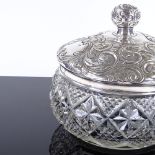 A large Edwardian silver-topped cut-glass dressing table powder jar, with relief embossed foliate