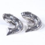 A pair of Norwegian sterling silver fish pepperettes, with relief embossed decoration, width 5cm (2)