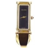 GUCCI - a lady's gold plated 1500 bangle quartz wristwatch, black face with rectangular case, case