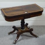 A Regency rosewood and satinwood inlaid fold over card table
