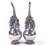 A pair of Islamic silver rose water sprinklers, in the form of a pear, with cast-silver floral