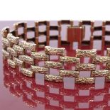 A 1970s 9ct gold gatelink bracelet, with textured panels, maker's marks JAM, hallmarks Birmingham