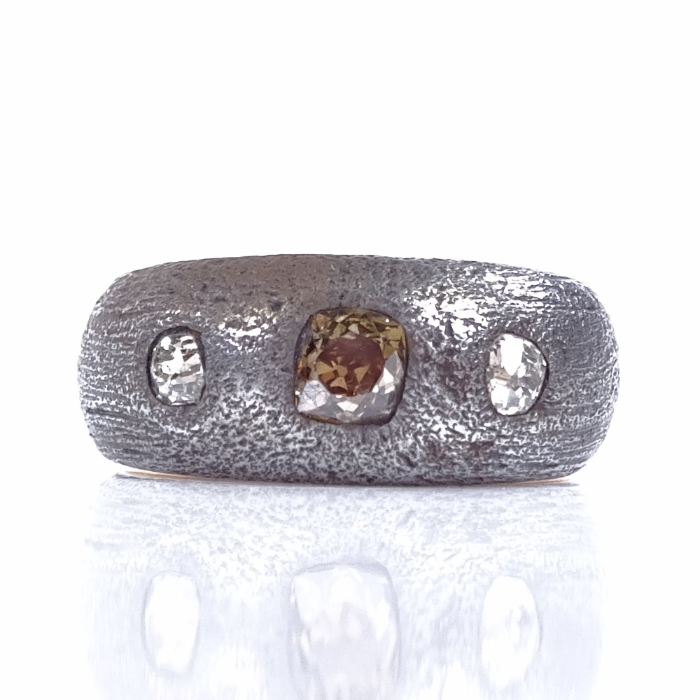 An unmarked gold and silver 3-stone champagne and colourless diamond gypsy ring, setting height 8.