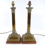 A pair of modern brass Corinthian column table lamps on wooden bases, height excluding fittings 40cm